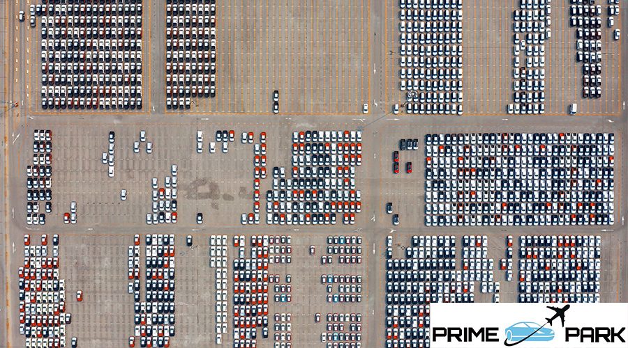 Aerial view of new cars at parking port in automobile factory.