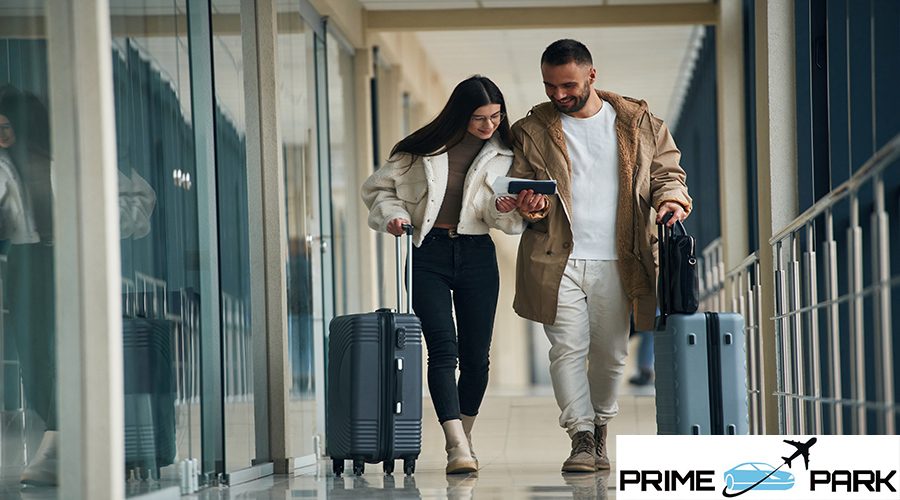 In the airport hall, walking. Couple are together.