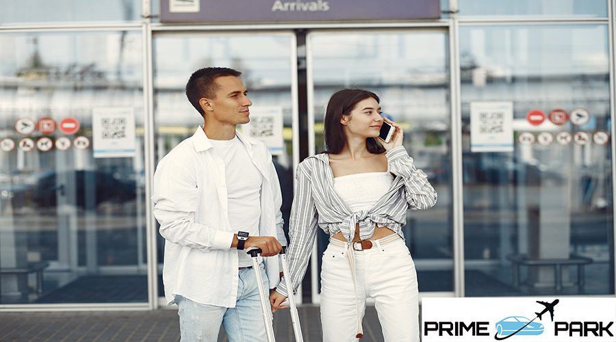 Couple in a airport. Beautiful brunette in a white shirt. Man in a white t-shirt