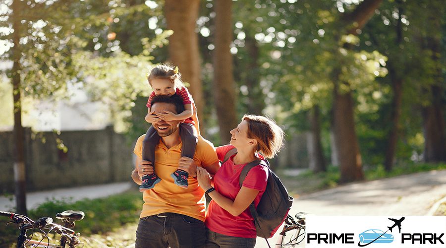 Family in a park. People with a bicycle. Parents with little daughter.