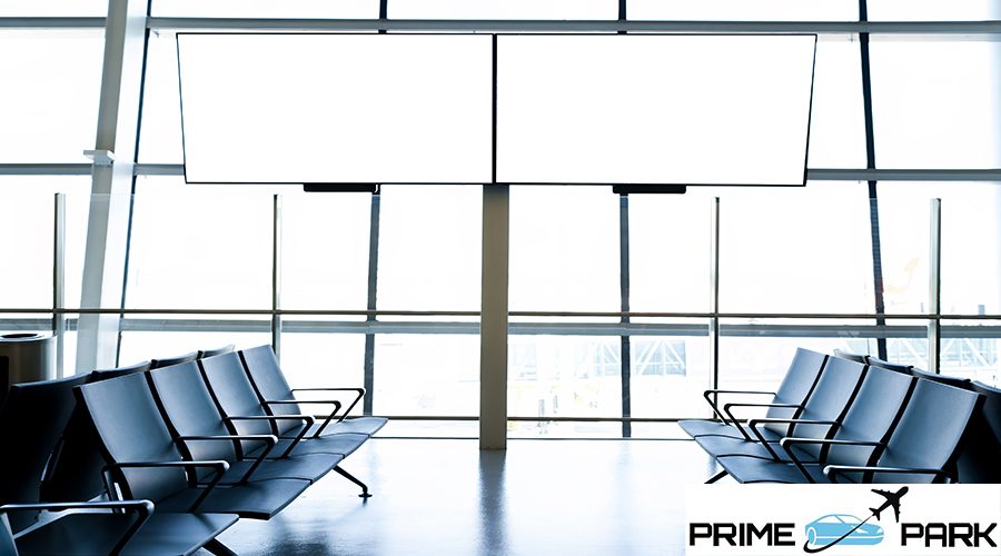 Departure lounge at the airport with seats in a row with TV