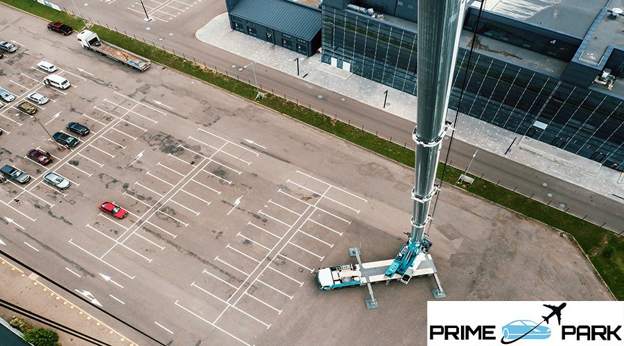 view from the height of the Car heavy crane that stands open in the Parking lot and ready to work. the highest truck crane is deployed on the site. the height of the boom is 80 meters.
