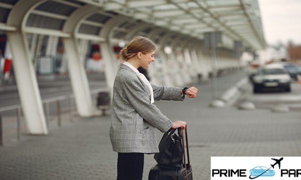 Woman by the airport. Girl with suitcase. Lady in a gray jacket.